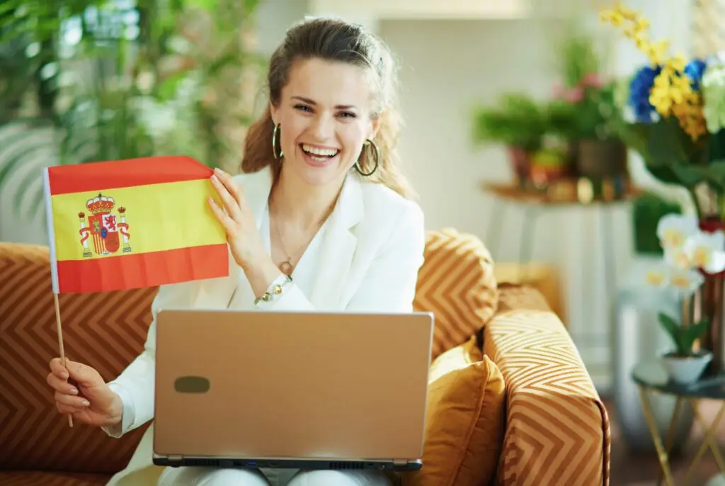 Woman with laptop and a spanish flag